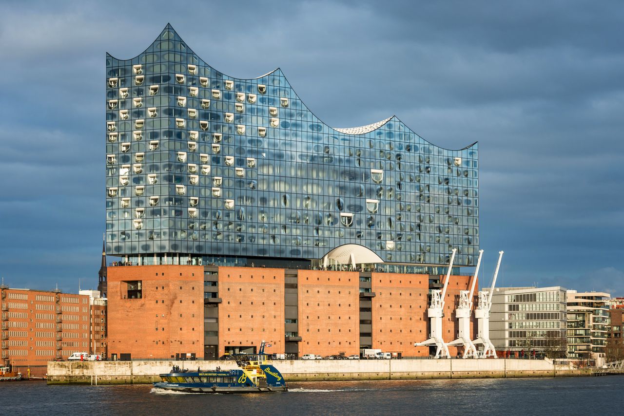 The Elbphilharmonie concert hall on Hamburg's Elbe river, its glass superstructure rising above a converted brick warehouse
