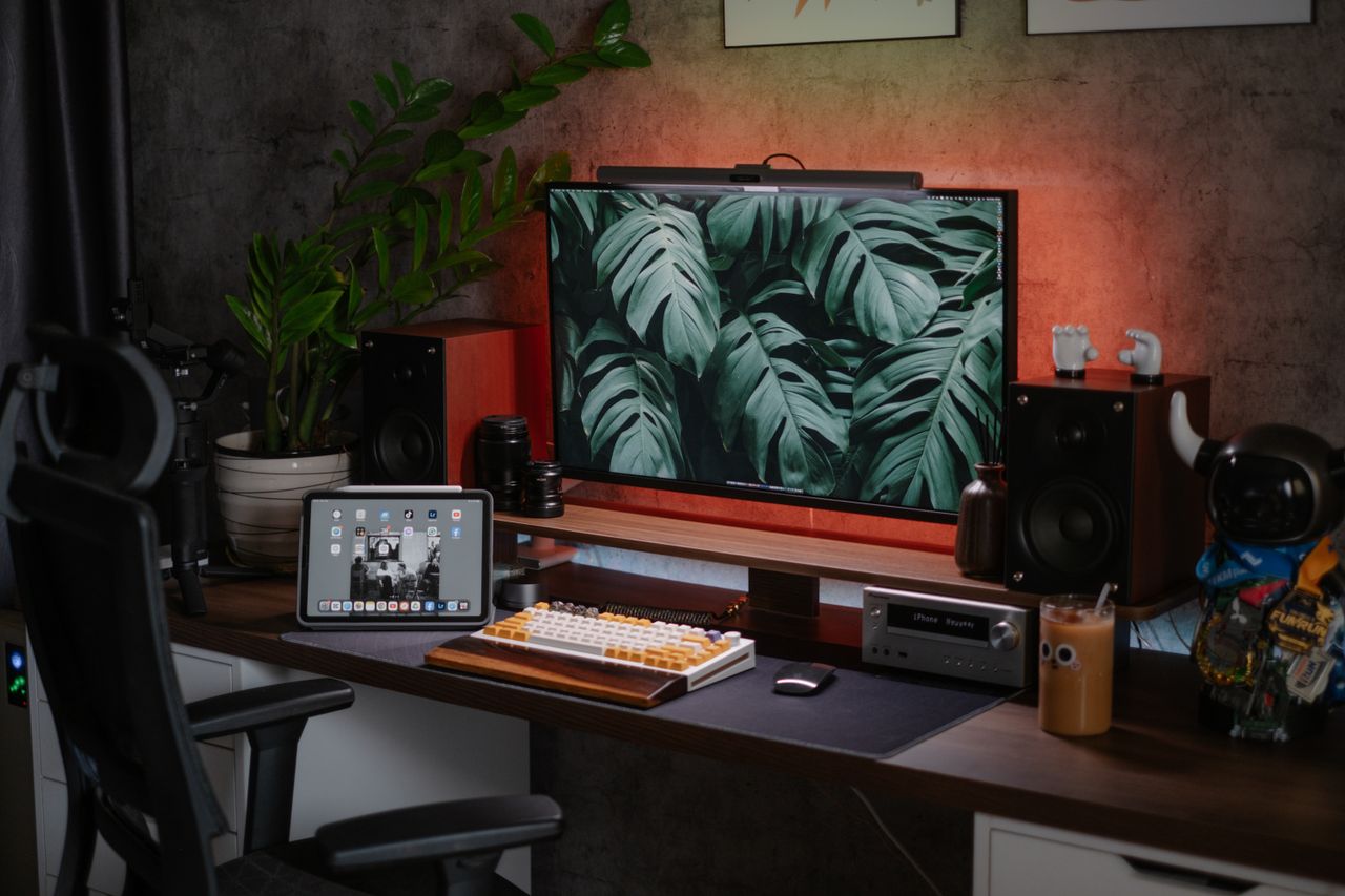 Interior design software open on a desktop monitor and tablet on a designer's desk